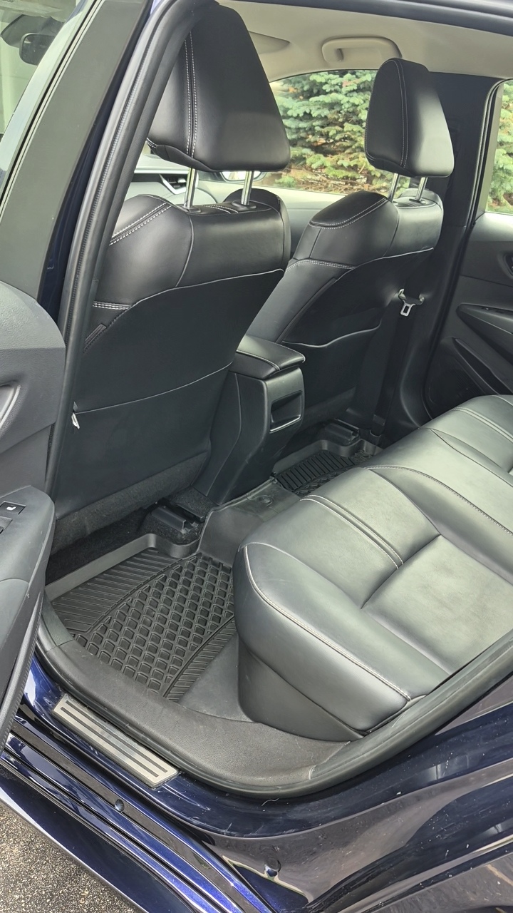 Driver seat area after detailing — spotless clean seat with restored leather and fresh appearance